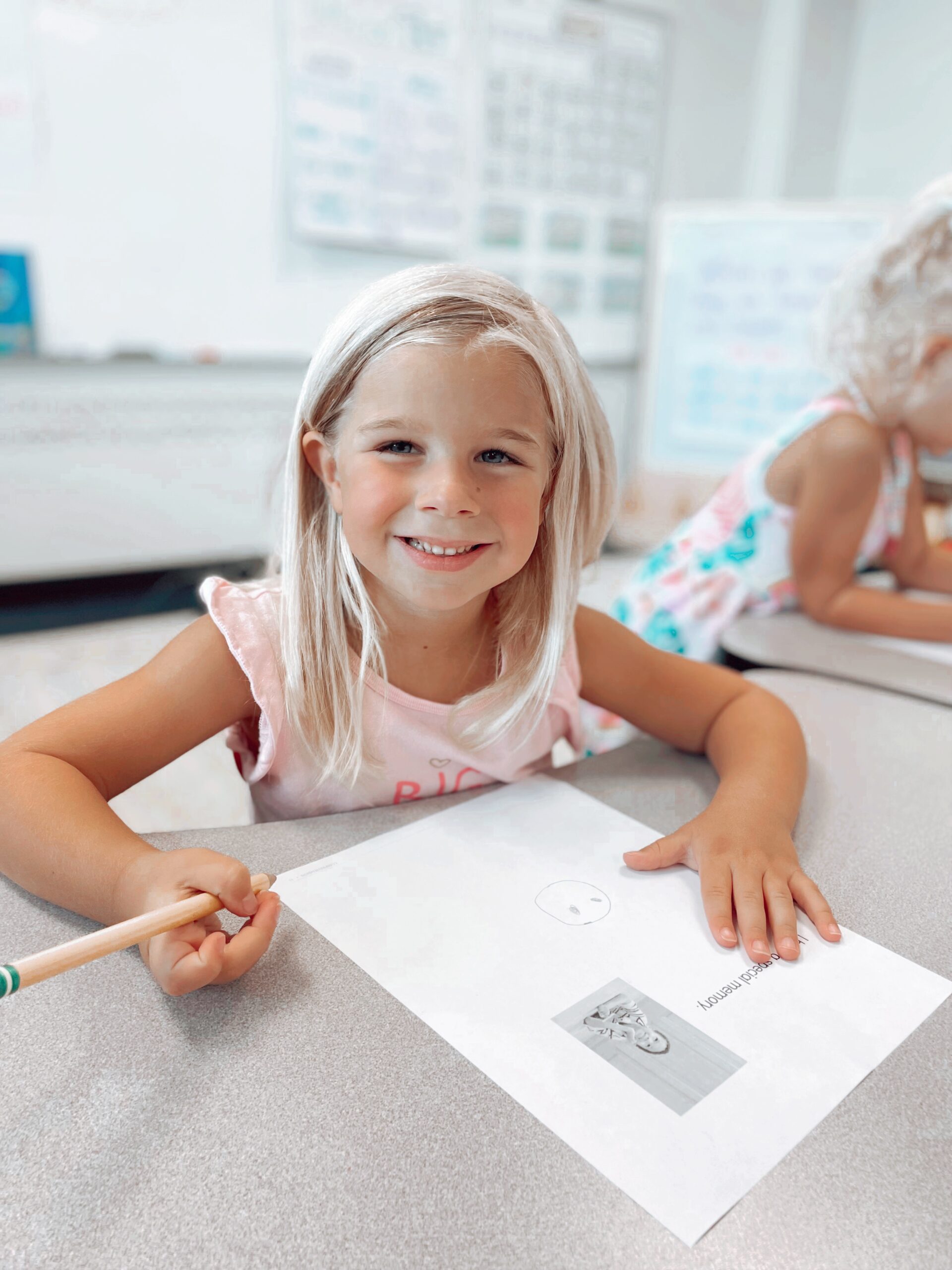 Kindergarten girl writing a letter